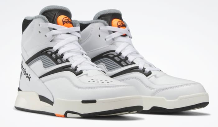 View of white and black Reebok shoes.